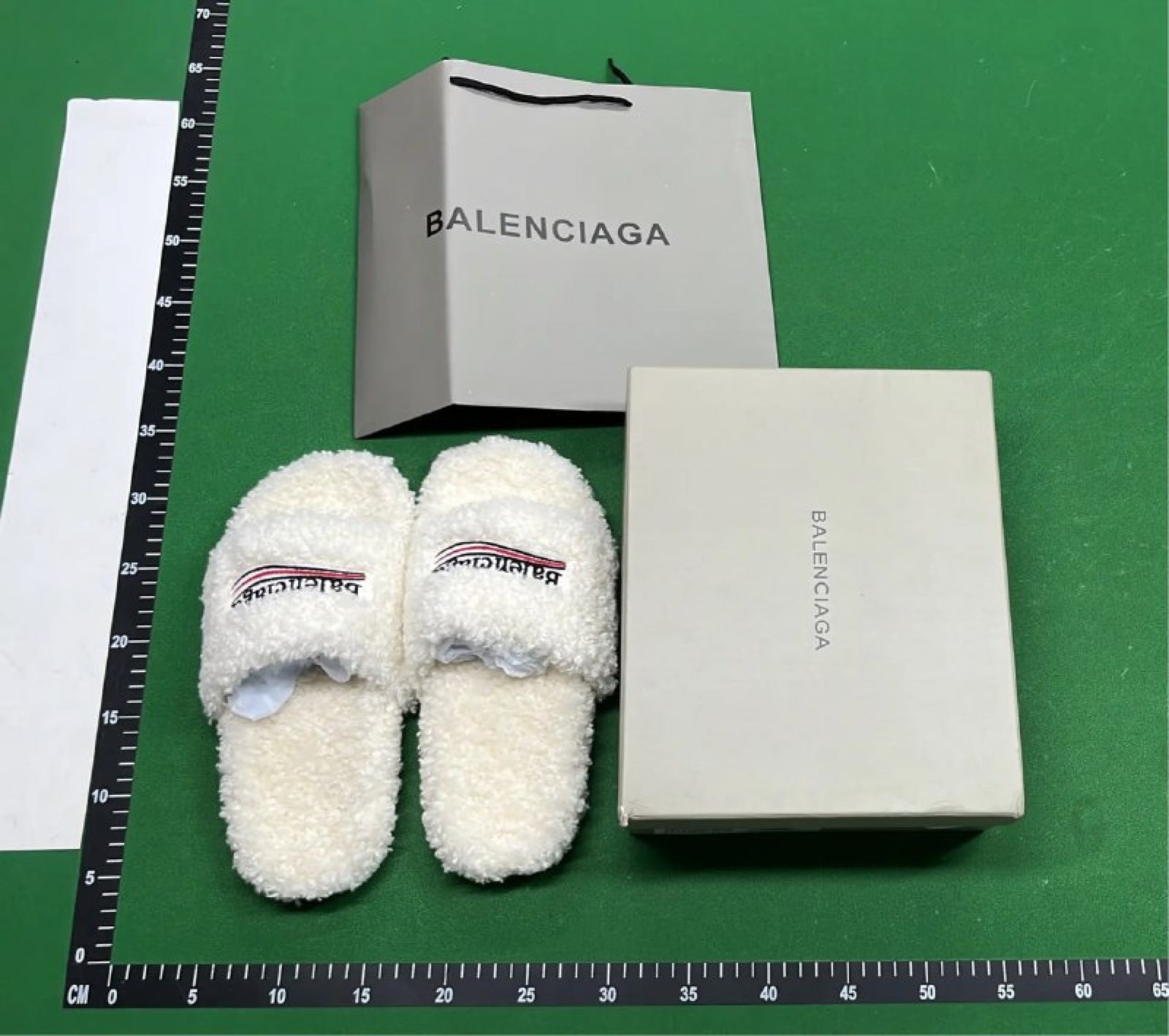 QC measurement photo showing an item and packaging on a measurement mat