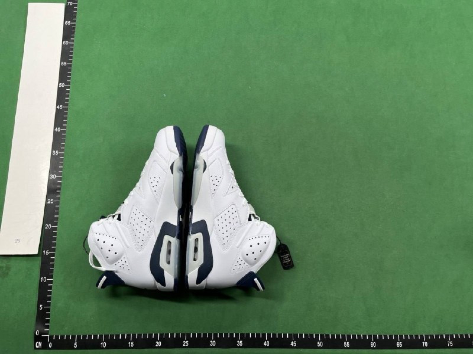 Warehouse QC photo showing a shoe on a measurement mat