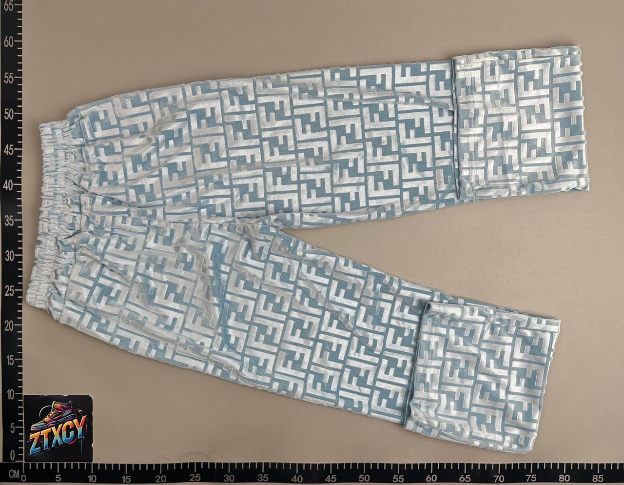 Patterned pants laid on a warehouse measurement board