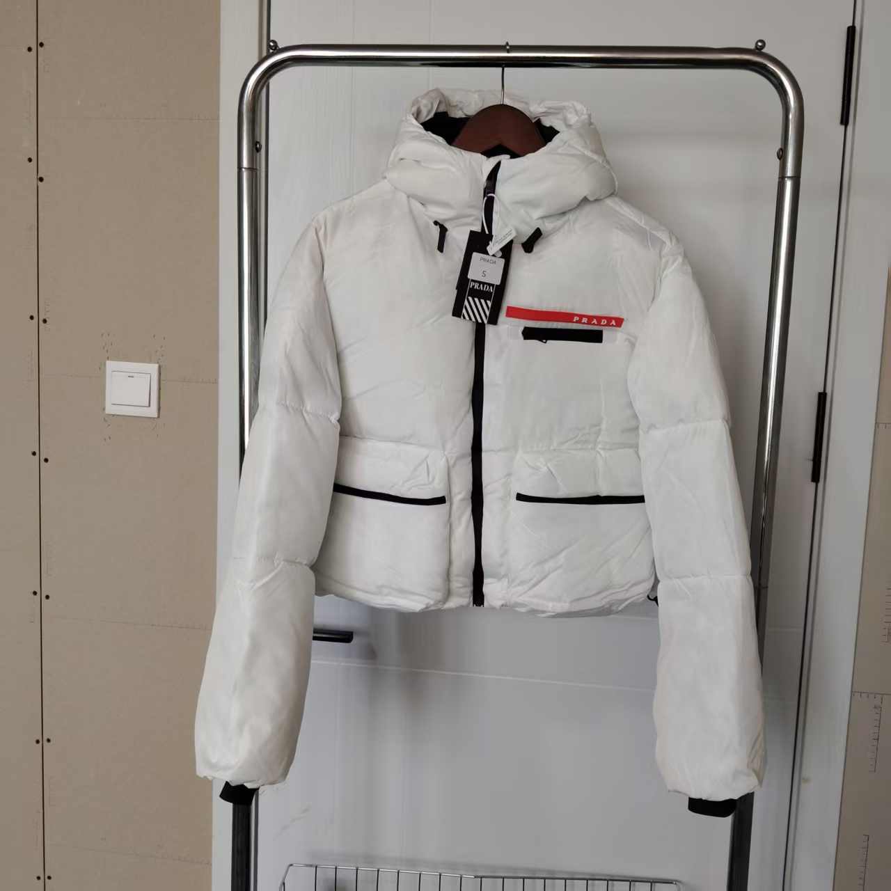 Short down jacket with a small white lettered logo
