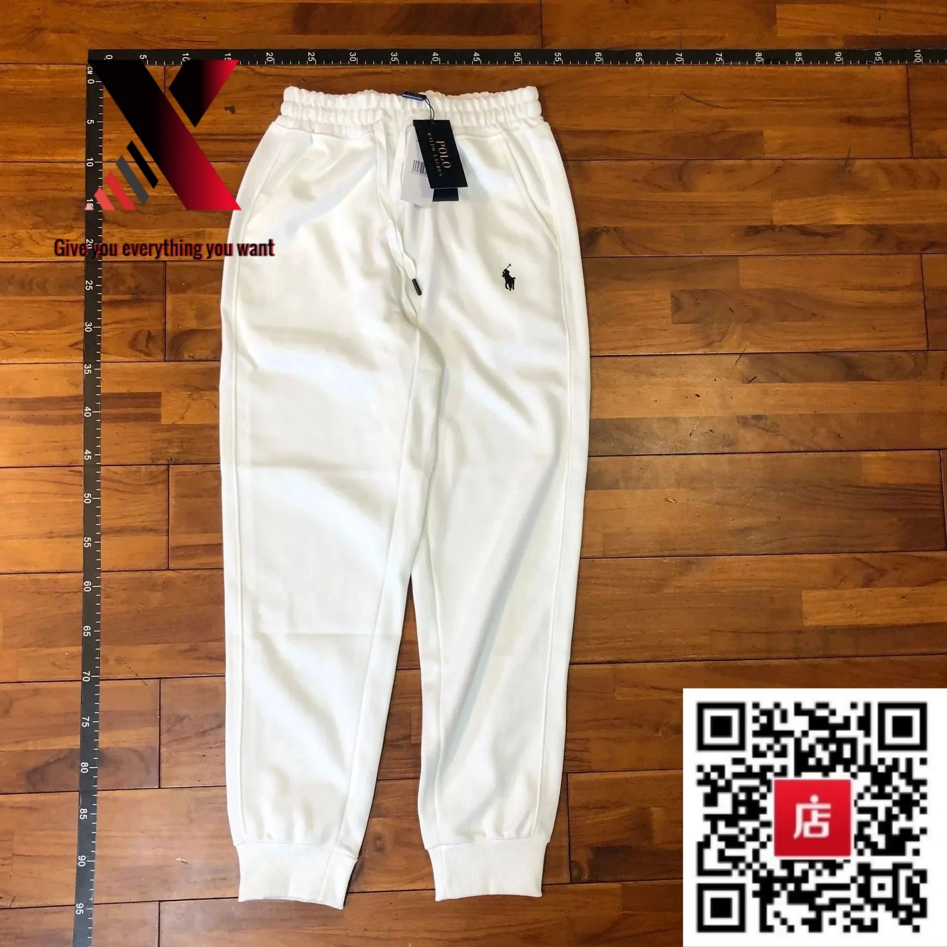 Real photo of white pants with a black label